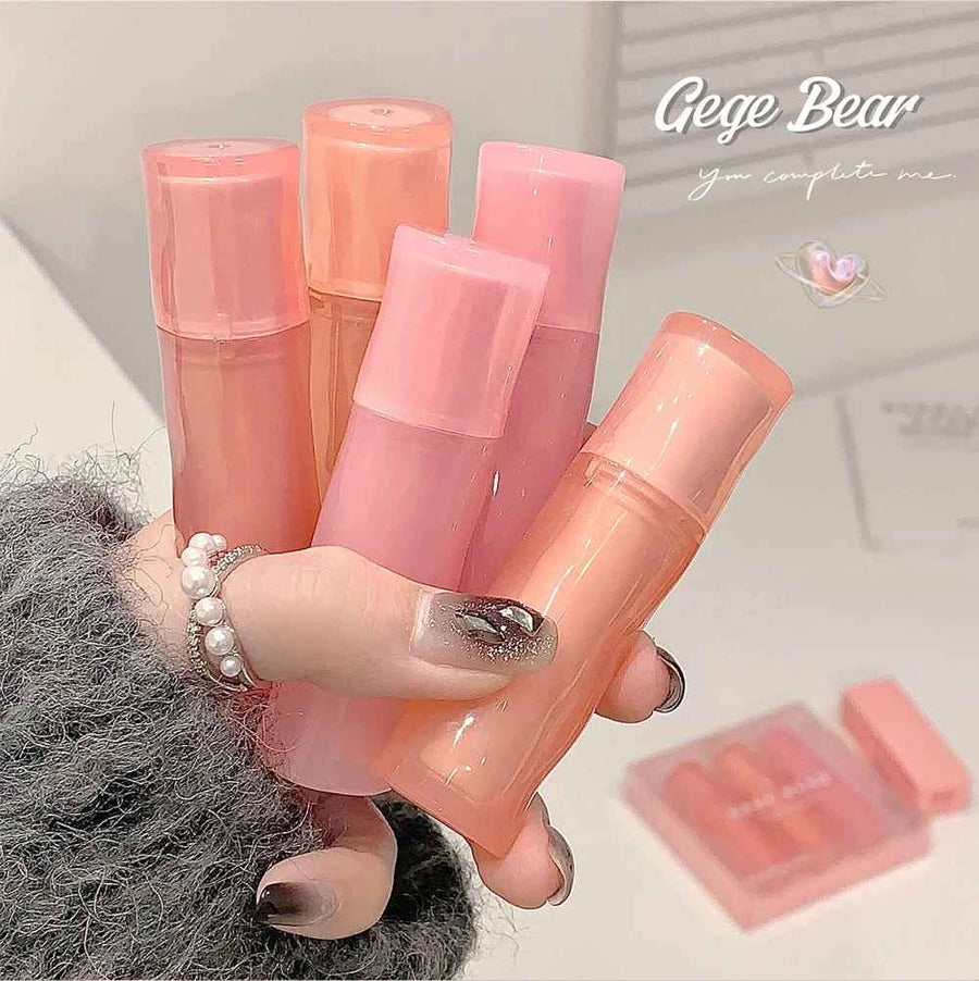 Hand holding pink lip balm tubes with 'Gege Bear' branding in the corner.