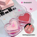 Heart-shaped pink lip balm with a laptop in the background