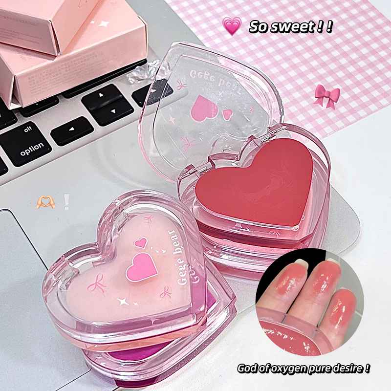 Heart-shaped pink lip balm with a laptop in the background