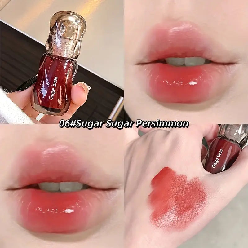 Lip gloss with 'Gege Bear' branding, shown on lips and swatched on skin in red shades 