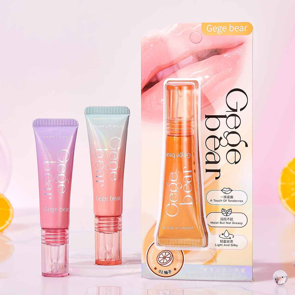 Gege bear lip gloss including tubes and a box on a light pink background