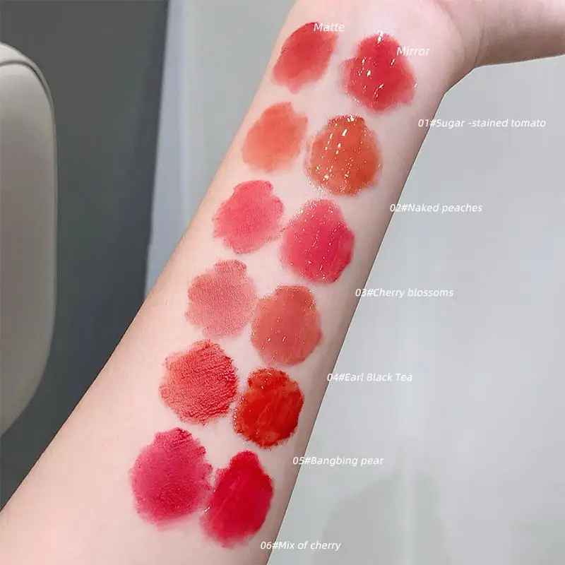 Lip gloss swatches on a person's arm with color names labeled