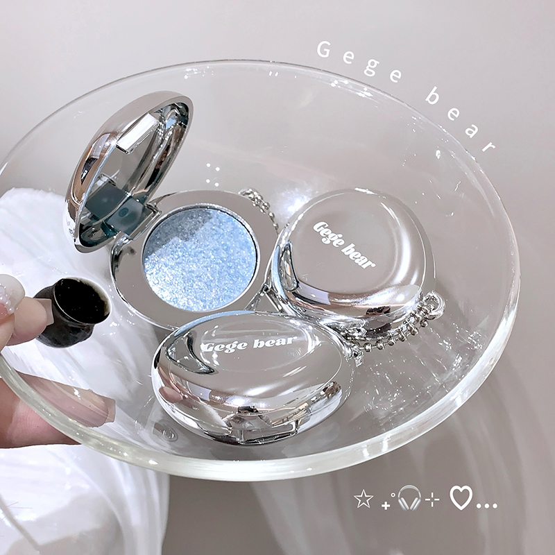 Makeup blush with 'Gege bear' branding on a clear stand.
