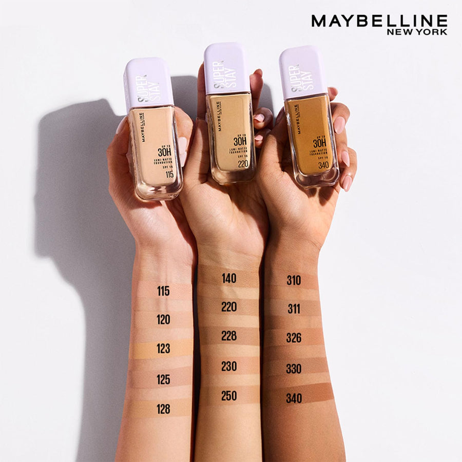 Three Maybelline New York foundation bottles held by hands with color swatches on a white background.