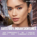 Advertisement for Maybelline New York makeup with a model against an urban background