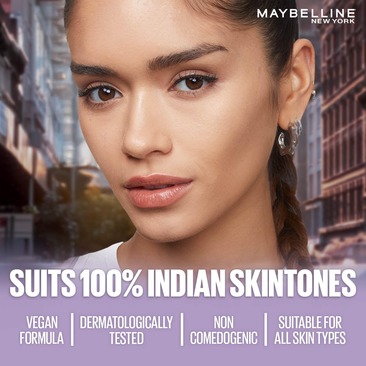 Advertisement for Maybelline New York makeup with a model against an urban background