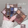 Makeup glitter eyeshadow palettes held by a hand with a dust background