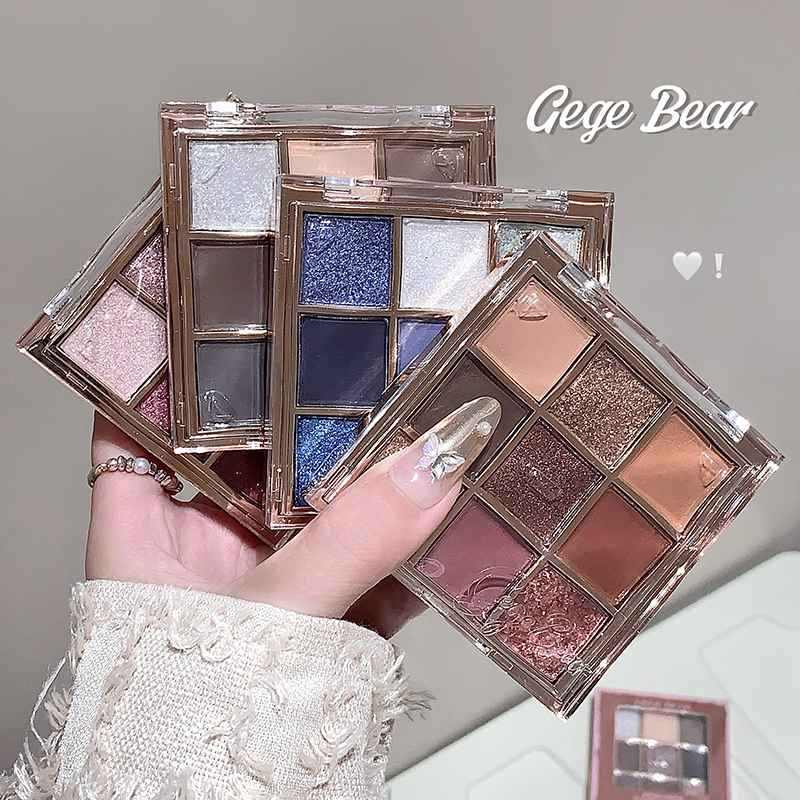 Makeup glitter eyeshadow palettes held by a hand with a dust background