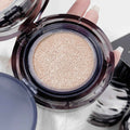 Open cushion foundation with beige powder held by a hand