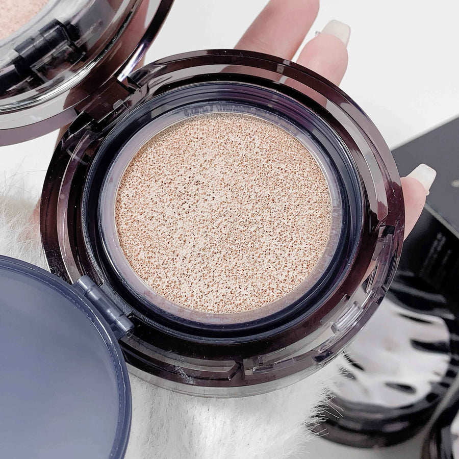 Open cushion foundation with beige powder held by a hand