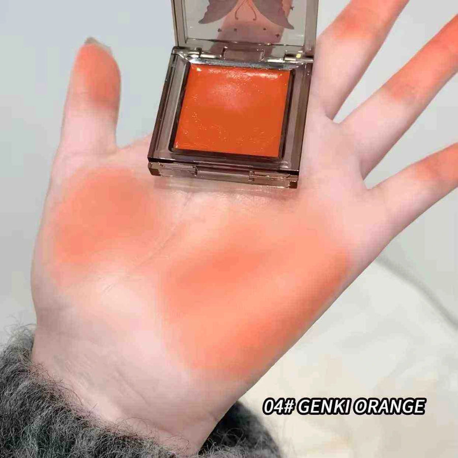 Hand holding a orange blush of Genki Orange blush with visible orange color swatch.