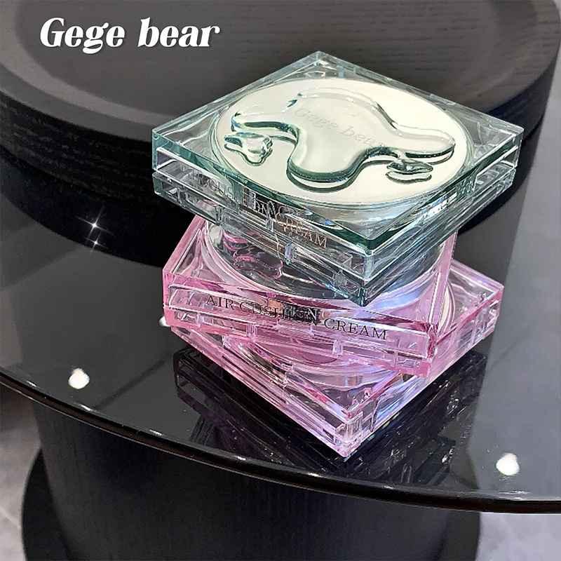 Pack of three Gege Bear cushion matte liquid foundations displayed on a black glass table, featuring light green and pink packaging colors with a clean product showcase setup.