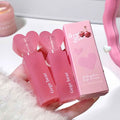 Pink lip cream with heart-shaped caps and 'Gege bear' branding on a white surface.