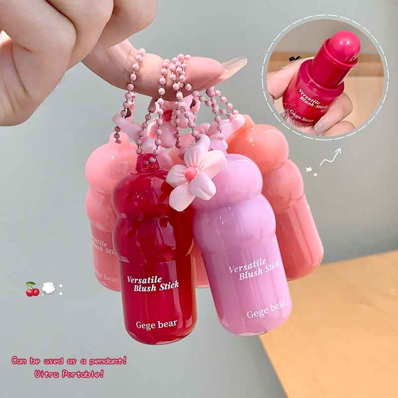 Pink and red Versatile Blush Sticks with floral design, held by a hand.