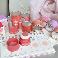Pink and red blush containers with 'Gege bear' branding on a planner.