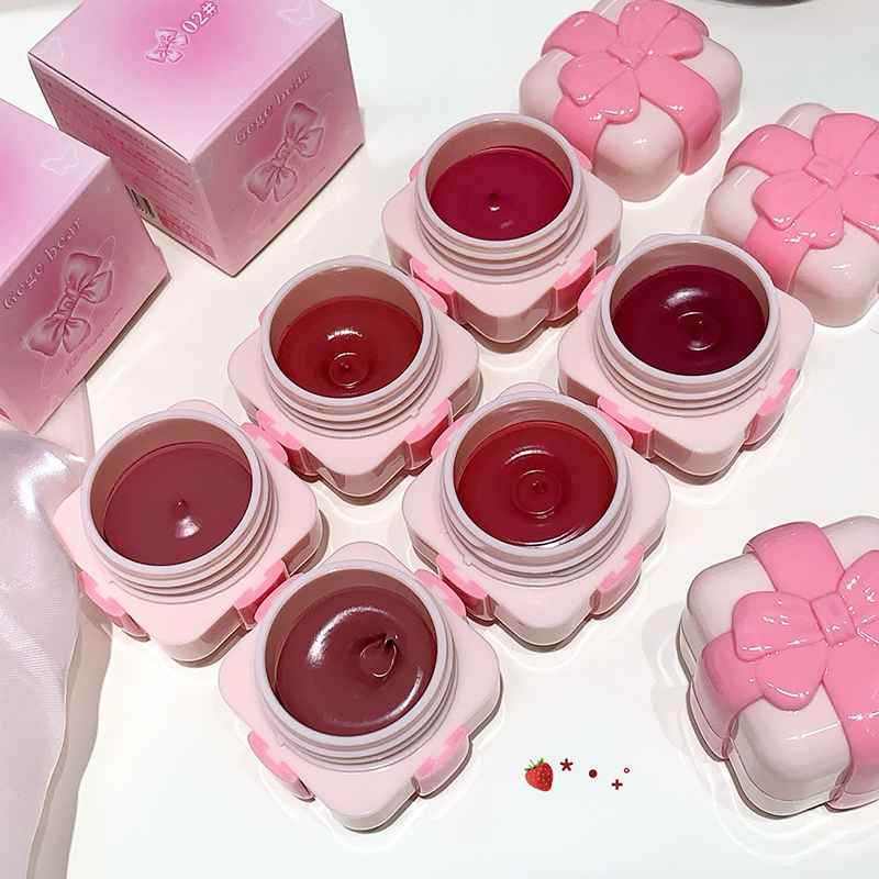 Pink blush containers with a strawberry design on a white background