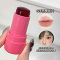 Pink blush stick held by a hand with a close-up of a lip color swatch and a person's face.