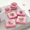 Pink blush with and dog cat illustrations on a white surface with Gege Bear branding.