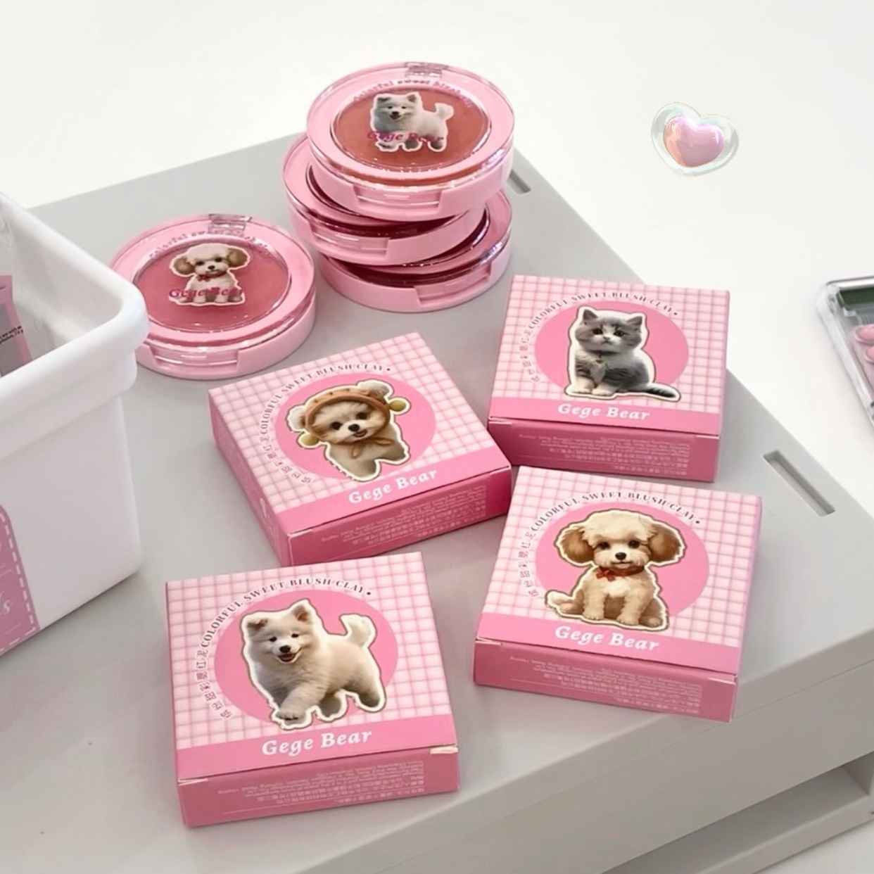 Pink blush with and dog cat illustrations on a white surface with Gege Bear branding.