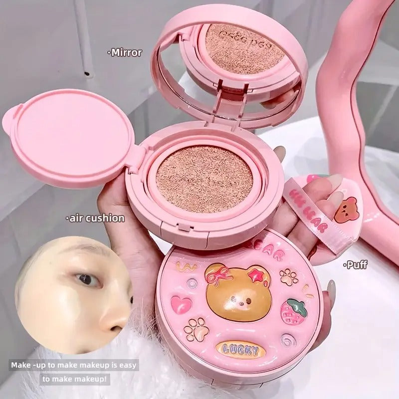 Pink foundation container with mirror, air cushion, and puff, featuring a bear design.