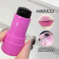 Pink lip balm stick held by a hand with a close-up of lips and face showing the color effect.