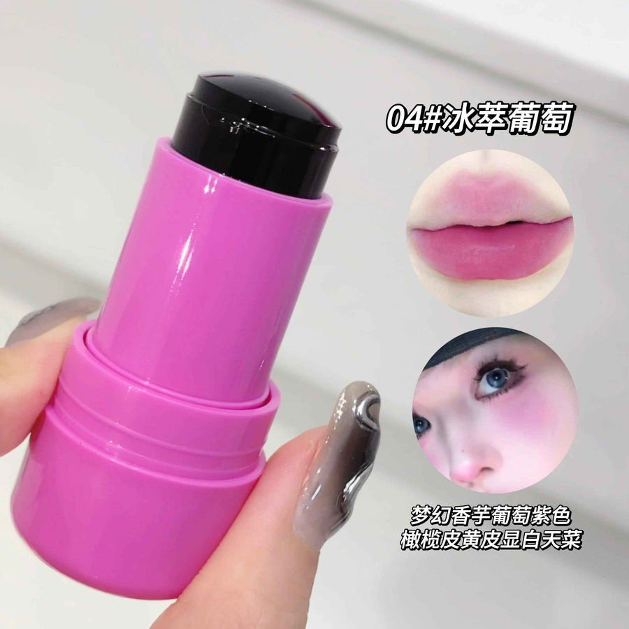 Pink lip balm stick held by a hand with a close-up of lips and face showing the color effect.