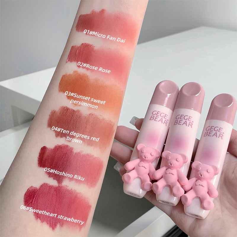 Pink lipstick with bear design and color swatches on a arm