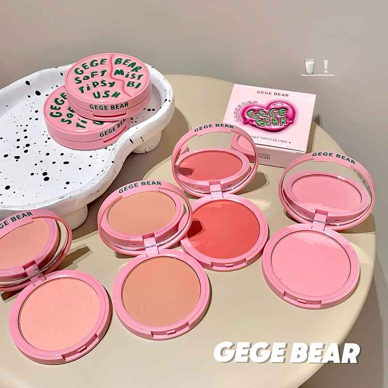 Pink makeup blush with 'GECE BEAR' branding on a light surface.