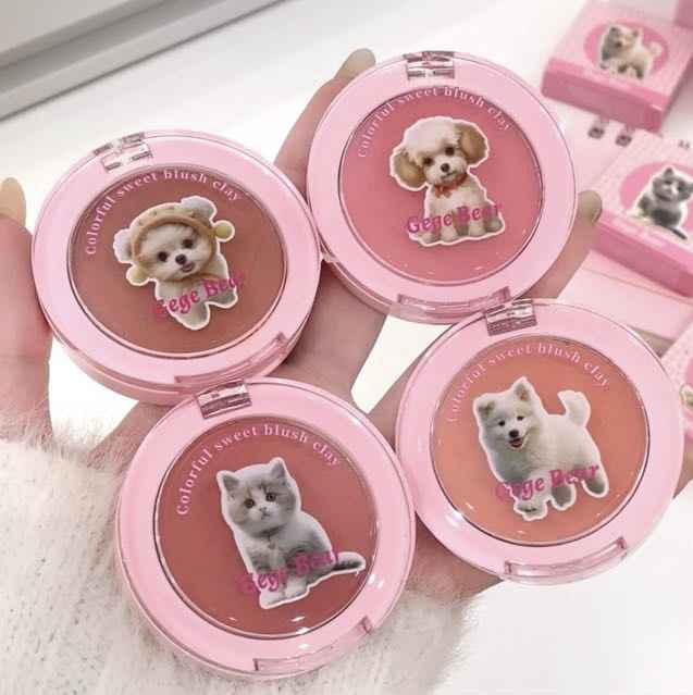 Pink makeup products with animal illustrations on a white background