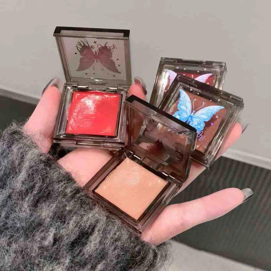 Three gege bear blushes palette with butterfly designs on the lids, held in a hand brand by gege bear 