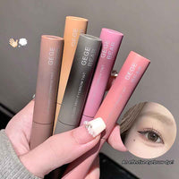 Set of GEGE BEAR eyebrow tint products held by a hand with a blurred background