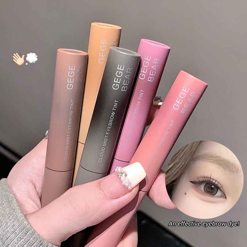 Set of GEGE BEAR eyebrow tint products held by a hand with a blurred background