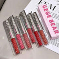 Set of GEGE BEAR lip glosses on a magazine background