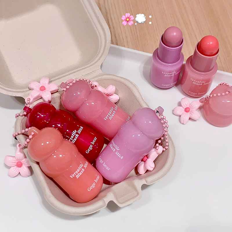 Set of  lip blush in a decorative holder on a light wooden surface.