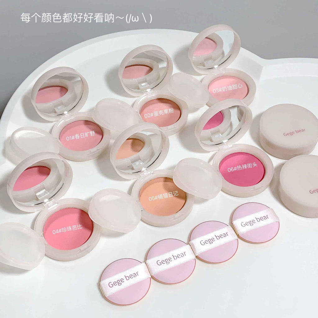 Set of pink and beige makeup products with 'Gege bear' branding on a white background.