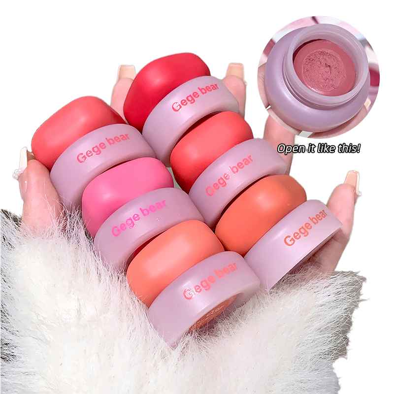 Set of pink and orange makeup Blush with 'Gage bear' branding held by a hand.