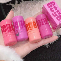 Set of pink blush sticks with 'gege bear' branding on a hand