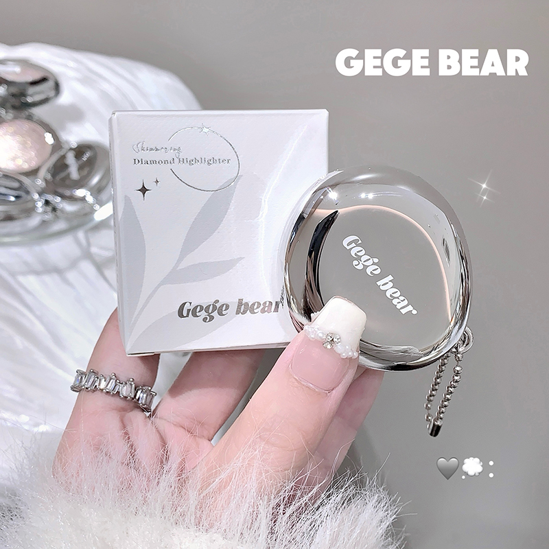 Blush  with 'GEGE BEAR' branding held by a hand, with packaging in the background.