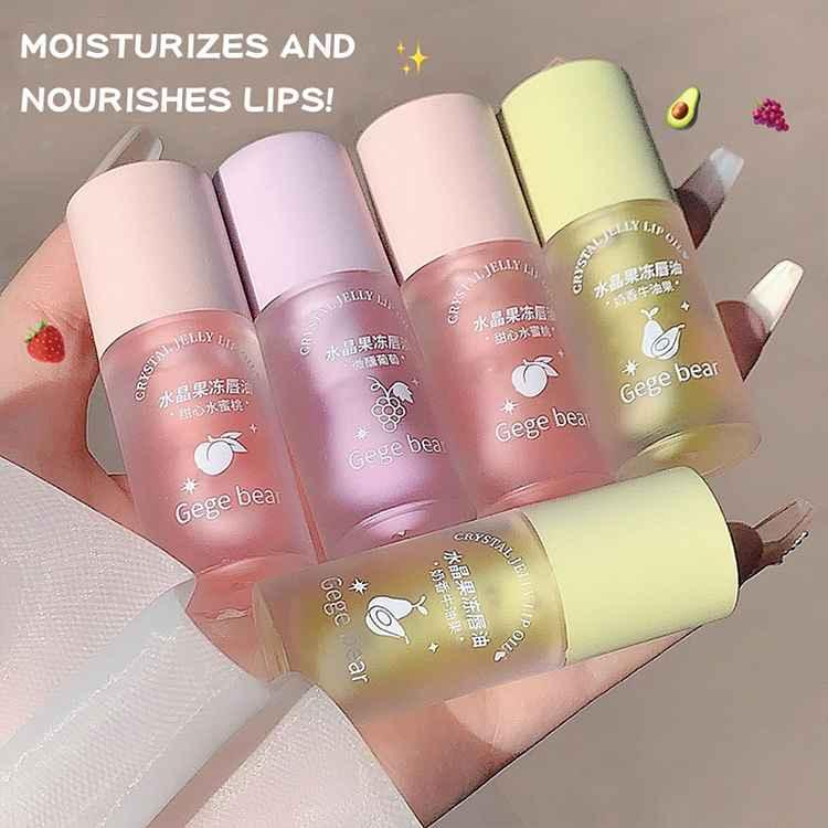 Six lip lip gloss with 'Gege bear' branding on a hand against a neutral background. Showing all three flavours 