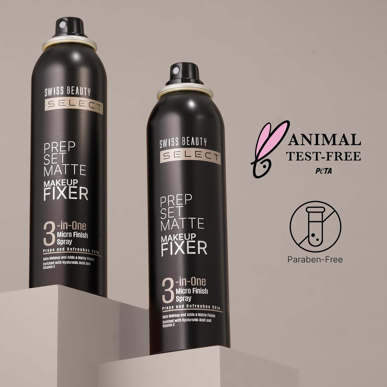 Two bottle of setting spray on bak round with 'animal test free' text .