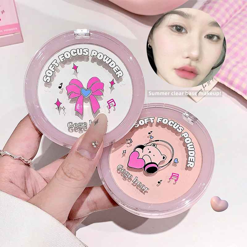 Two containers of 'Soft Focus Powder' with cartoon designs on a light pink background.