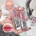 Two lip glosses held in a hand with a close-up of lips wearing the product, set against a blurred background.