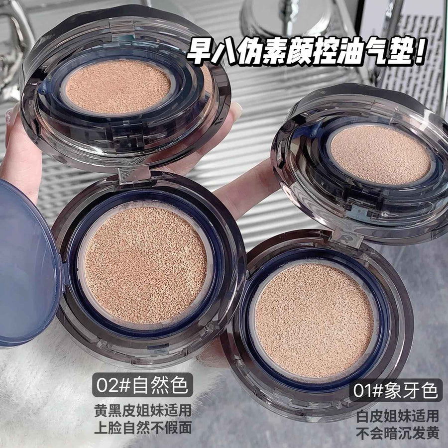 Two open cushion foundation cases with different shades of beige on a reflective surface.