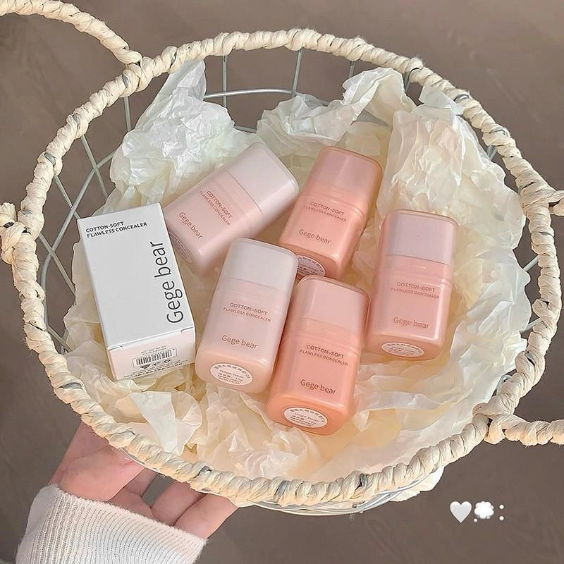 Basket with pink and white best concealer online in nepal and bottles labeled 'Cotton Bear' on a neutral background