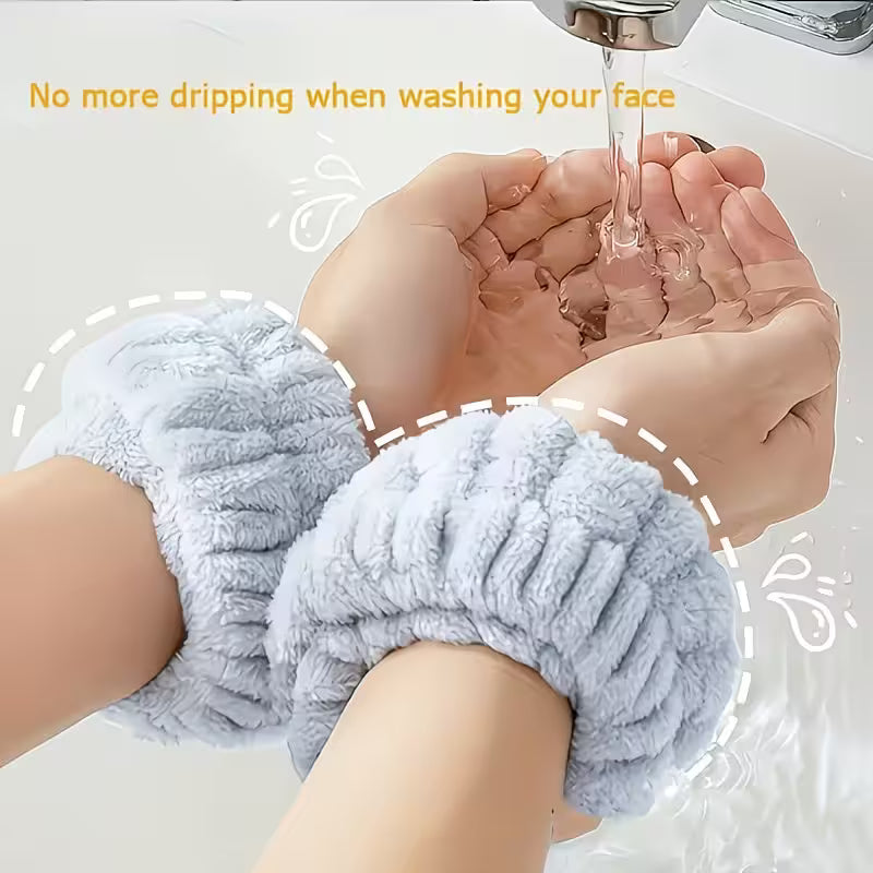 a pair of wristbands in blue color a lady is using it while washing her hands wristbands observing water stopping it to drip to her elbow 