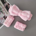 set of headband and wristbands in baby pink color on a grey background 