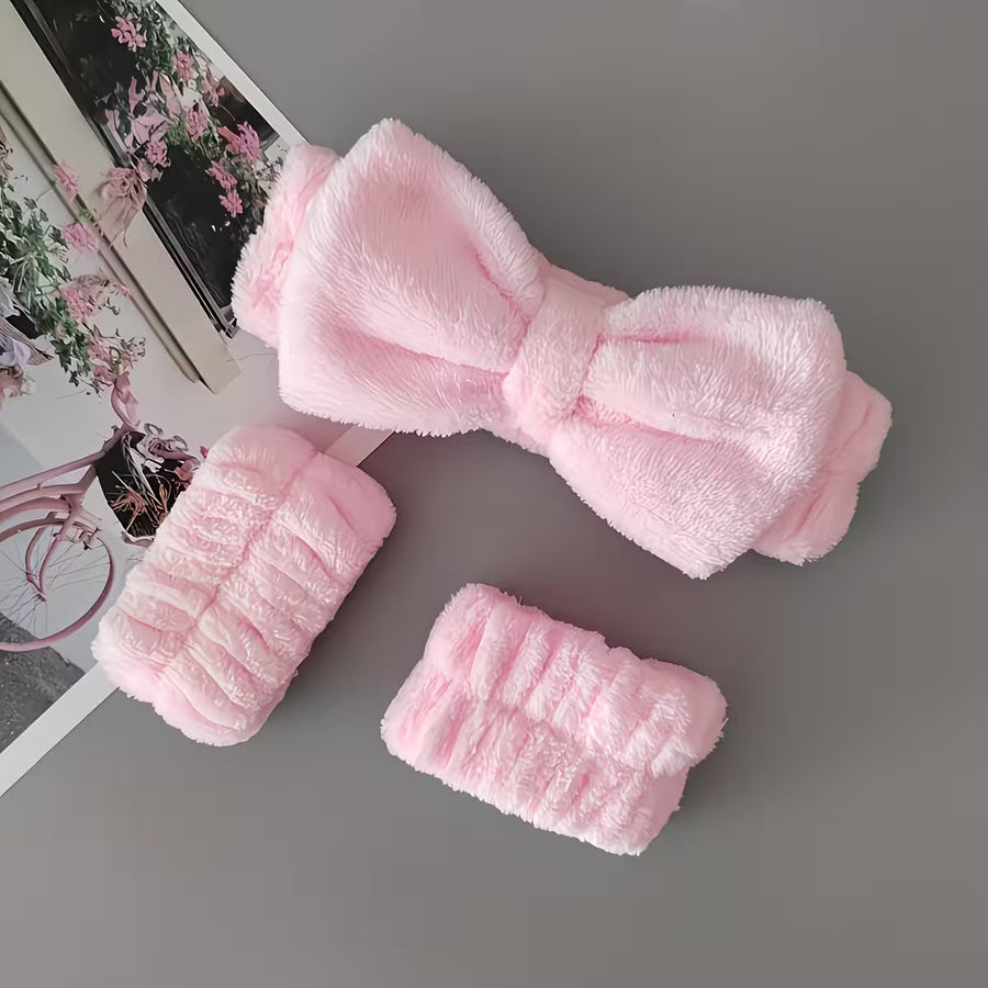 set of headband and wristbands in baby pink color on a grey background 