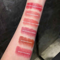 Lipstick swatches on a person's arm with color names labeled