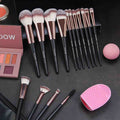 Makeup brushes and accessories on a dark surface