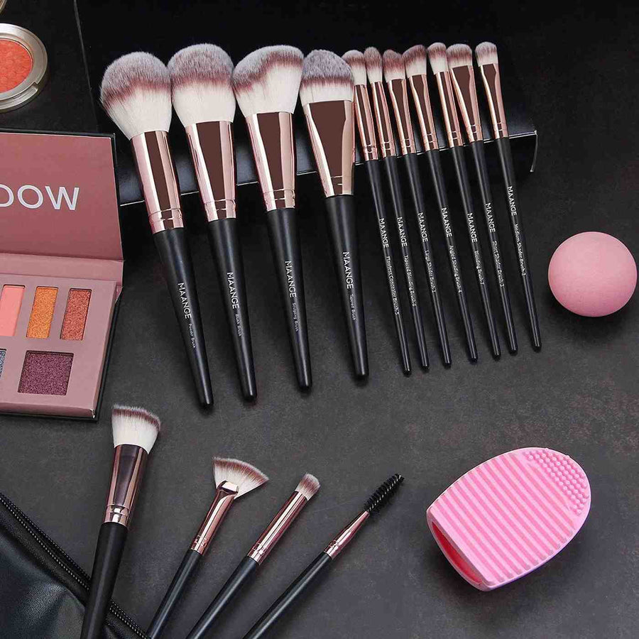 Makeup brushes and accessories on a dark surface